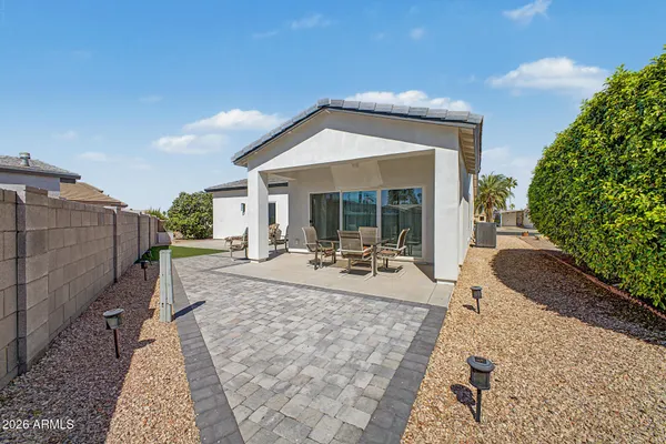 a view of a house with backyard and sitting area