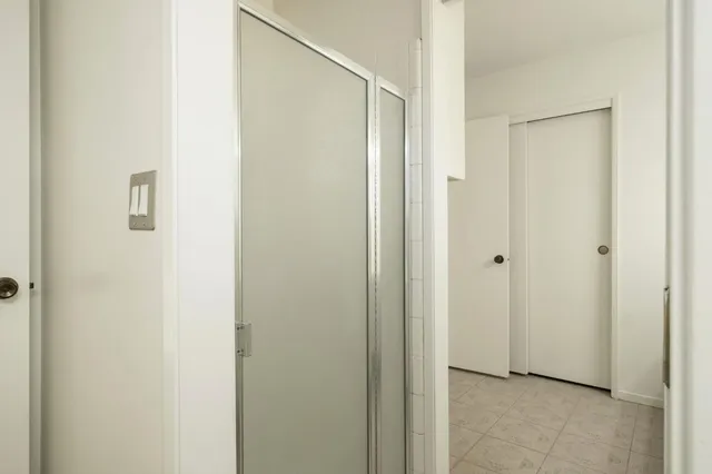 a view of a bathroom with a glass shower door