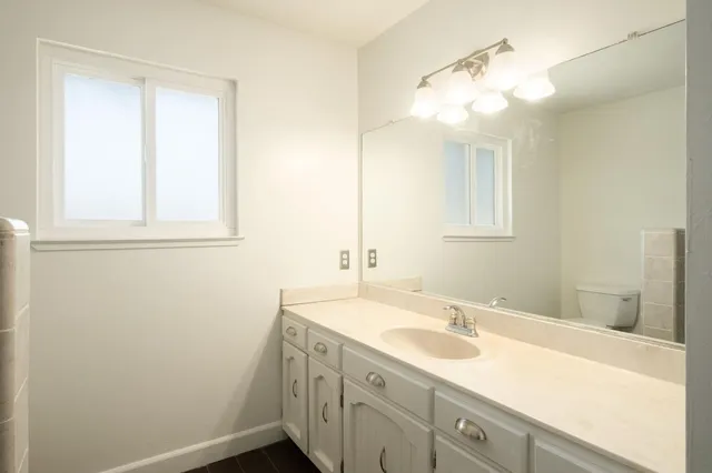 a bathroom with a sink a vanity and a mirror