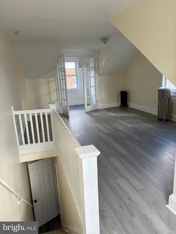 a view of front door and hallway with wooden floor