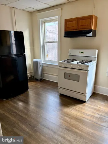 a kitchen with stainless steel appliances a stove a microwave and a refrigerator