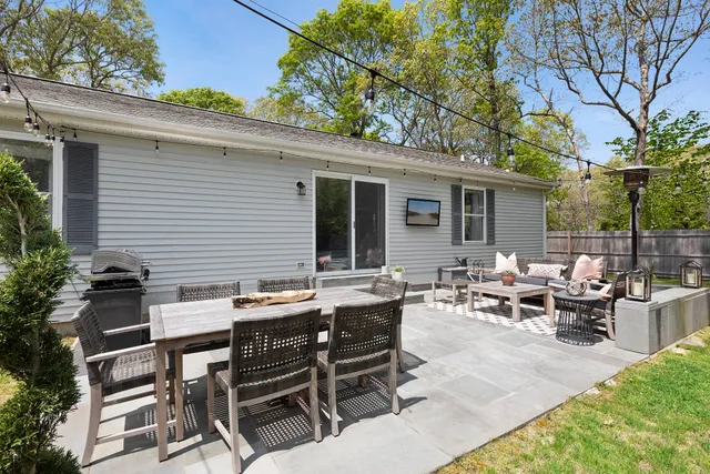 a view of a patio with table and chairs and potted plants