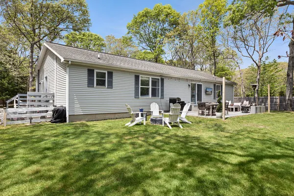 a backyard of a house with table and chairs