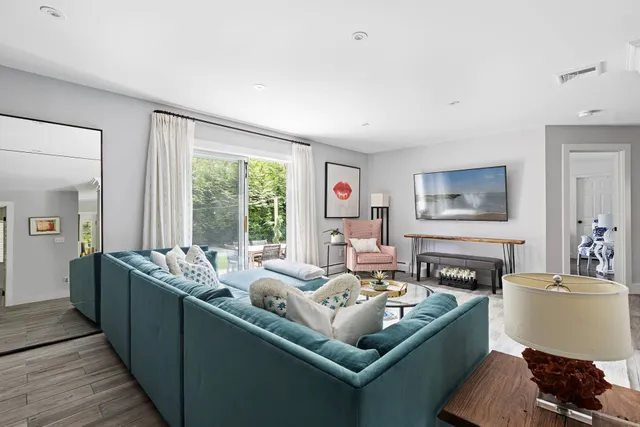 a living room with furniture and large windows