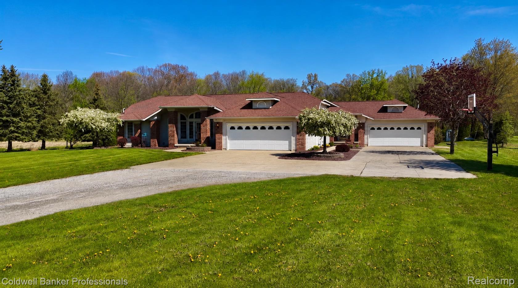 6464 Ferden Road Chesaning, MI 48616 - Photo 23 of 23 Ranch-style house featuring a front yard, an attached garage, driveway, and brick siding