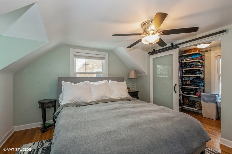 130 Northgate Road Riverside, IL 60546 - Photo 9 of 18 a bedroom with a bed and a chandelier