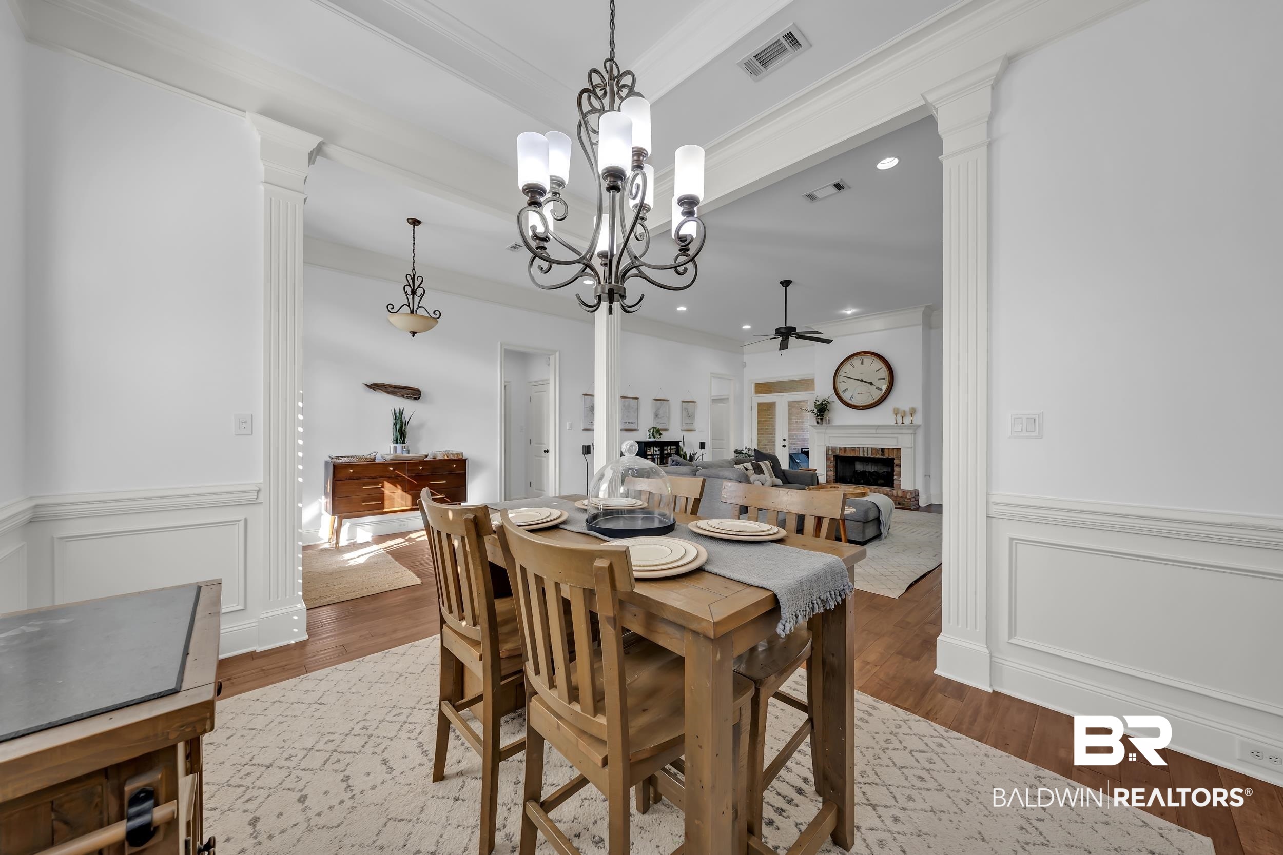 8137 Pine Run Daphne, AL 36527 - Photo 9 of 67 Hardwood flooring throughout the main living areas complemented by white wainscoting and crown molding
