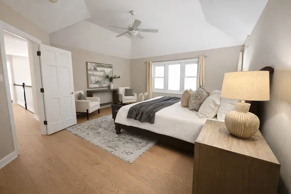 a spacious bedroom with a bed and window