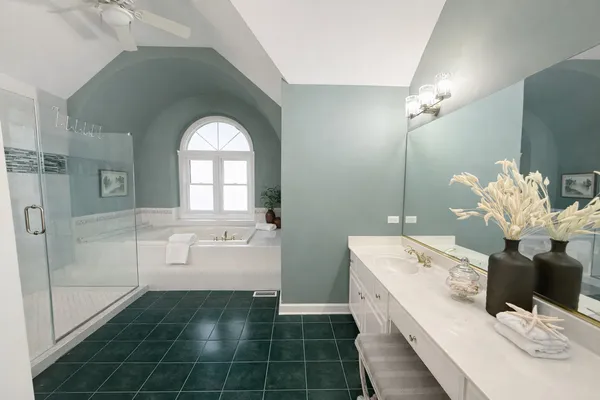 a bathroom with a bathtub sink and mirror