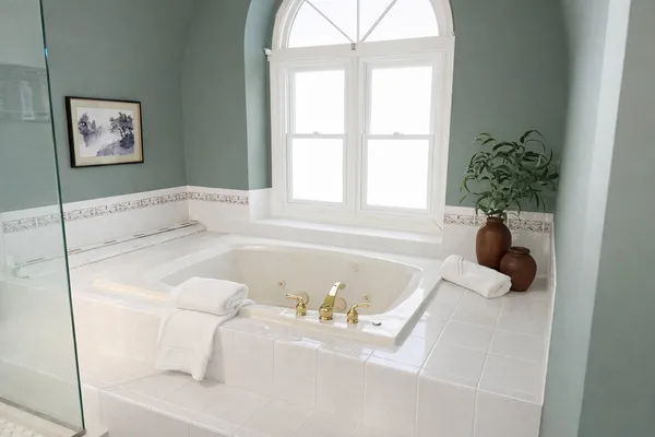 a bathroom with a tub sink and window