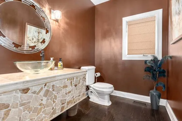 a bathroom with a sink a toilet and mirror