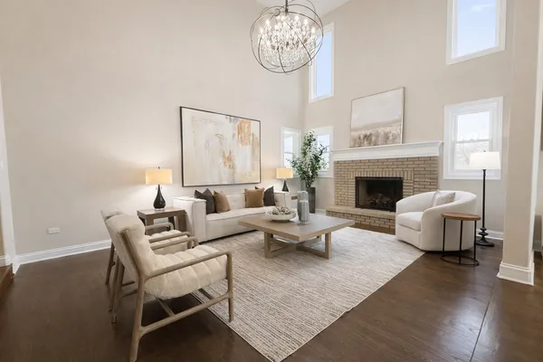 a living room with furniture or chandelier and a fireplace