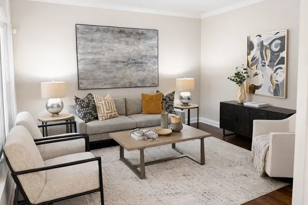 a living room with furniture and wooden floor