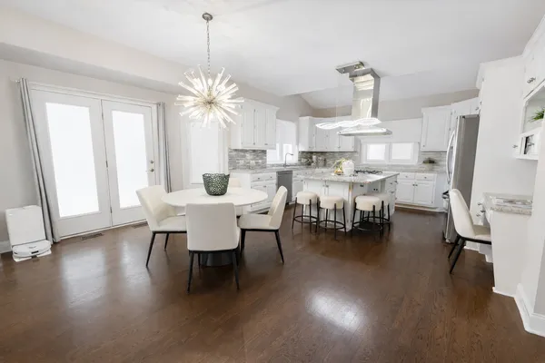 a view of a dining room with furniture and a chandelier