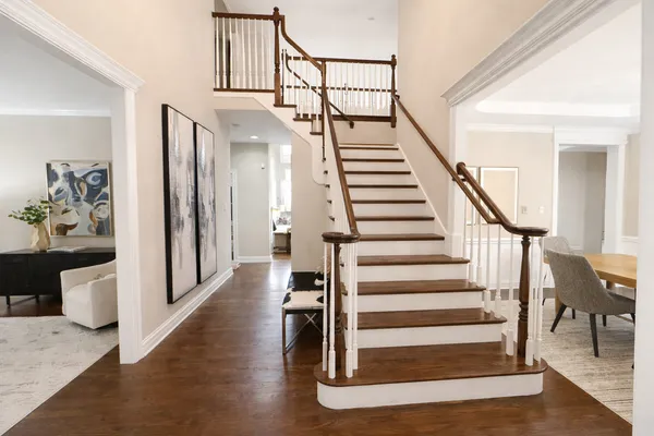 a view of entryway and hall with wooden floor