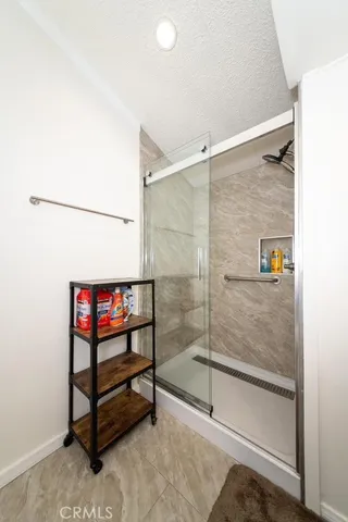 a bathroom with a shower and a sink