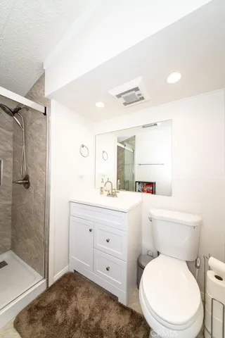 a white toilet sitting next to a bathroom sink