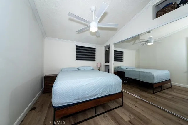 a bedroom with a bed a chandelier and window