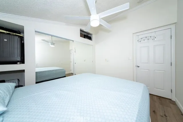 a bedroom with a bed and a ceiling fan