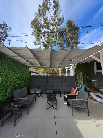 a view of outdoor space with seating area and trees around