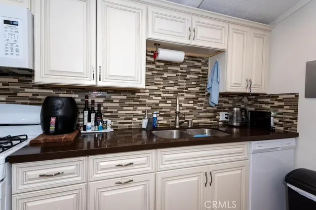 a kitchen with appliances cabinets and a counter top space