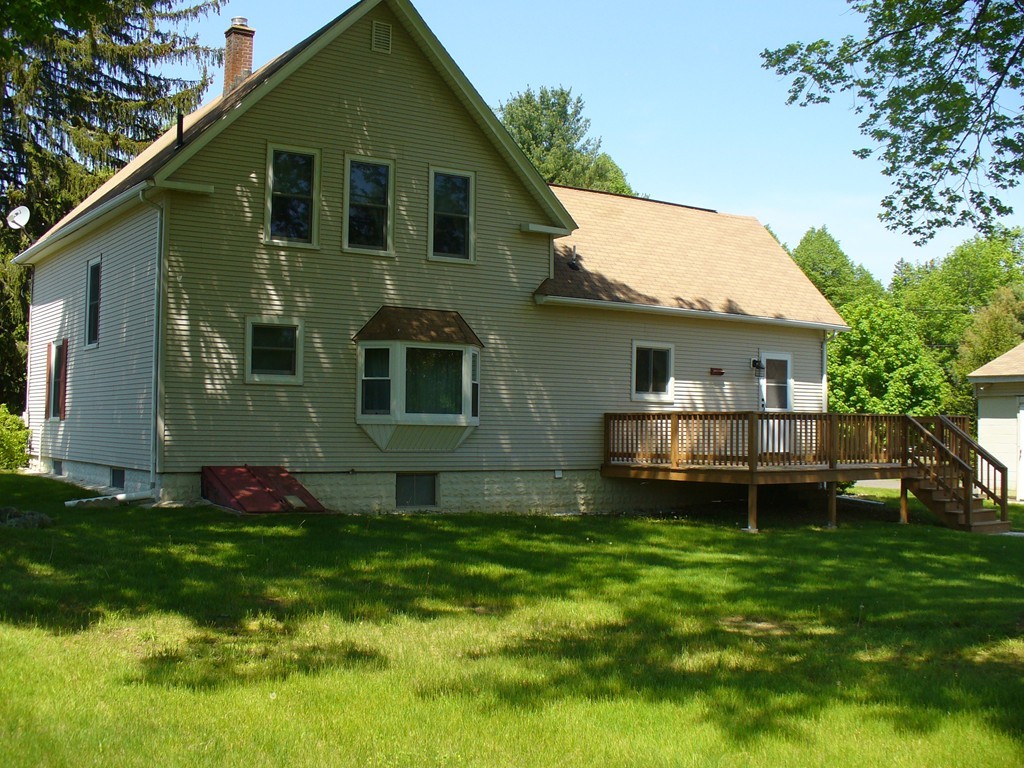 358 Palmer Road Ware, MA 01082 - Photo 24 of 30 a view of a house with a yard and sitting area