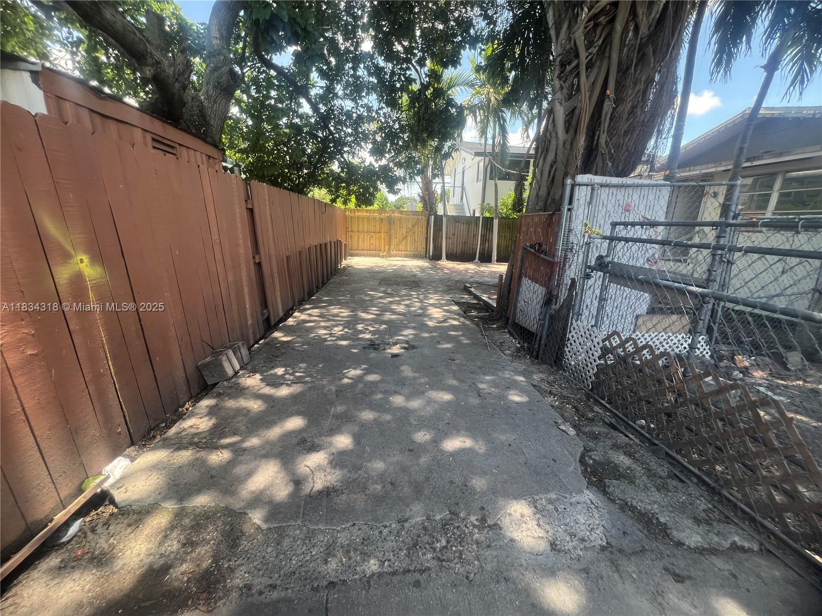 1800 Southwest 3rd Street, Unit C Miami, FL 33135 - Photo 5 of 13 a view of backyard with tree and wooden fence