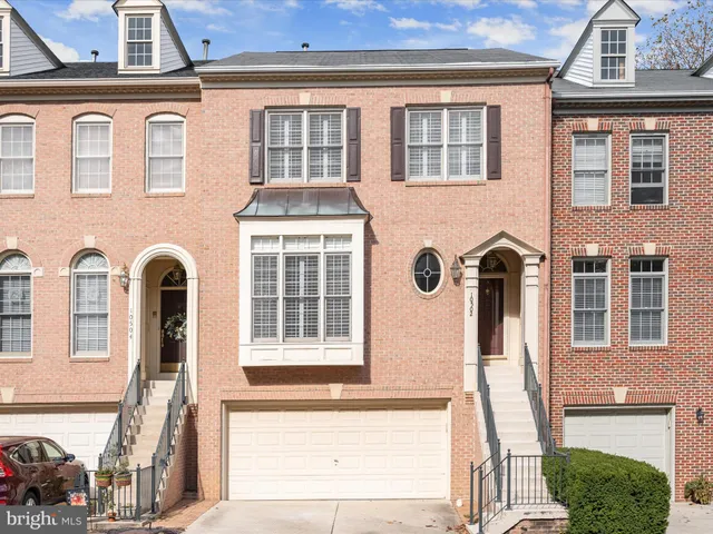 a front view of a house with many windows