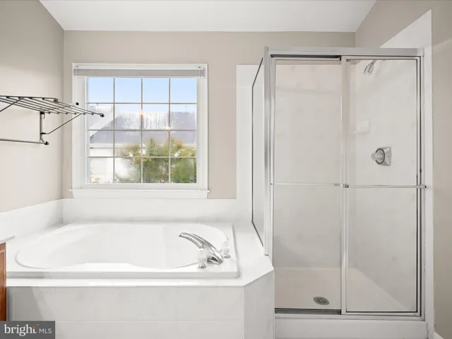a white bath tub sitting next to a window