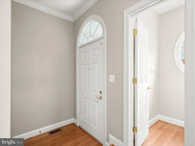 a view of front door with wooden floor