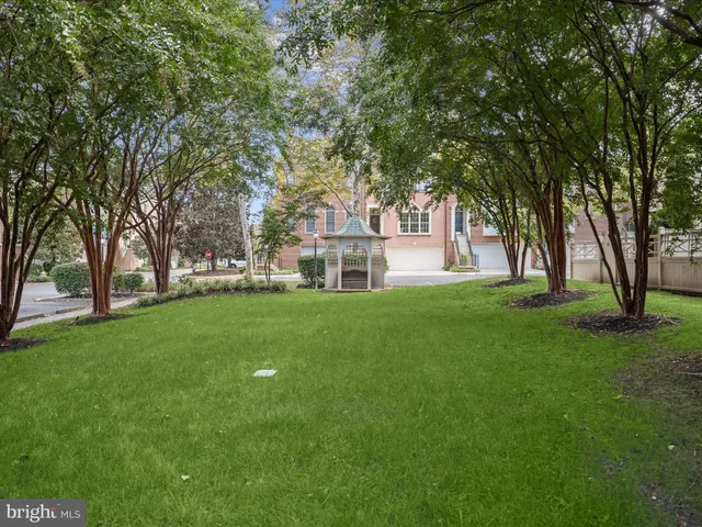 a view of house with backyard and trees