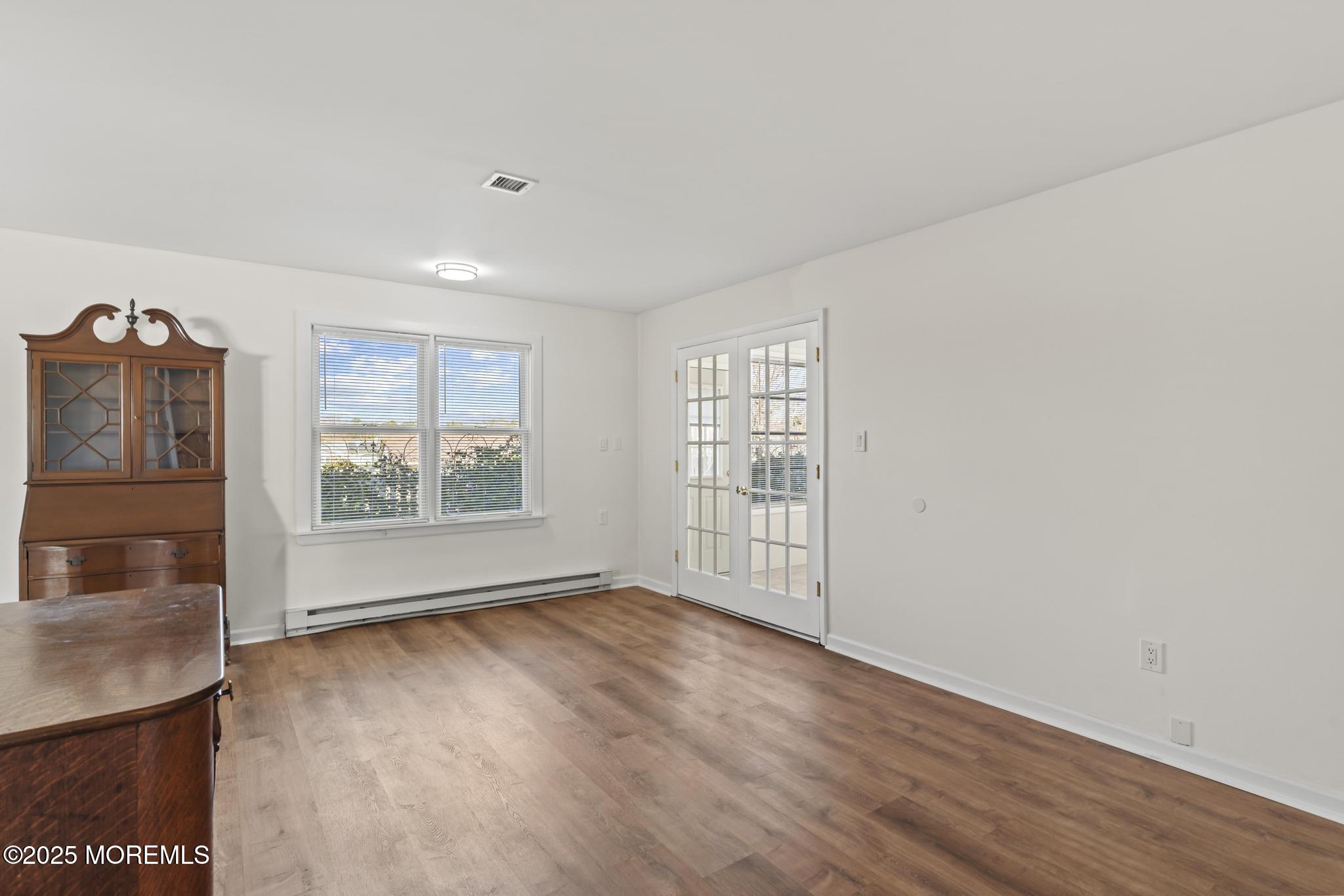 43 Patmore Road Brick, NJ 08724 - Photo 18 of 36 an empty room with wooden floor and windows
