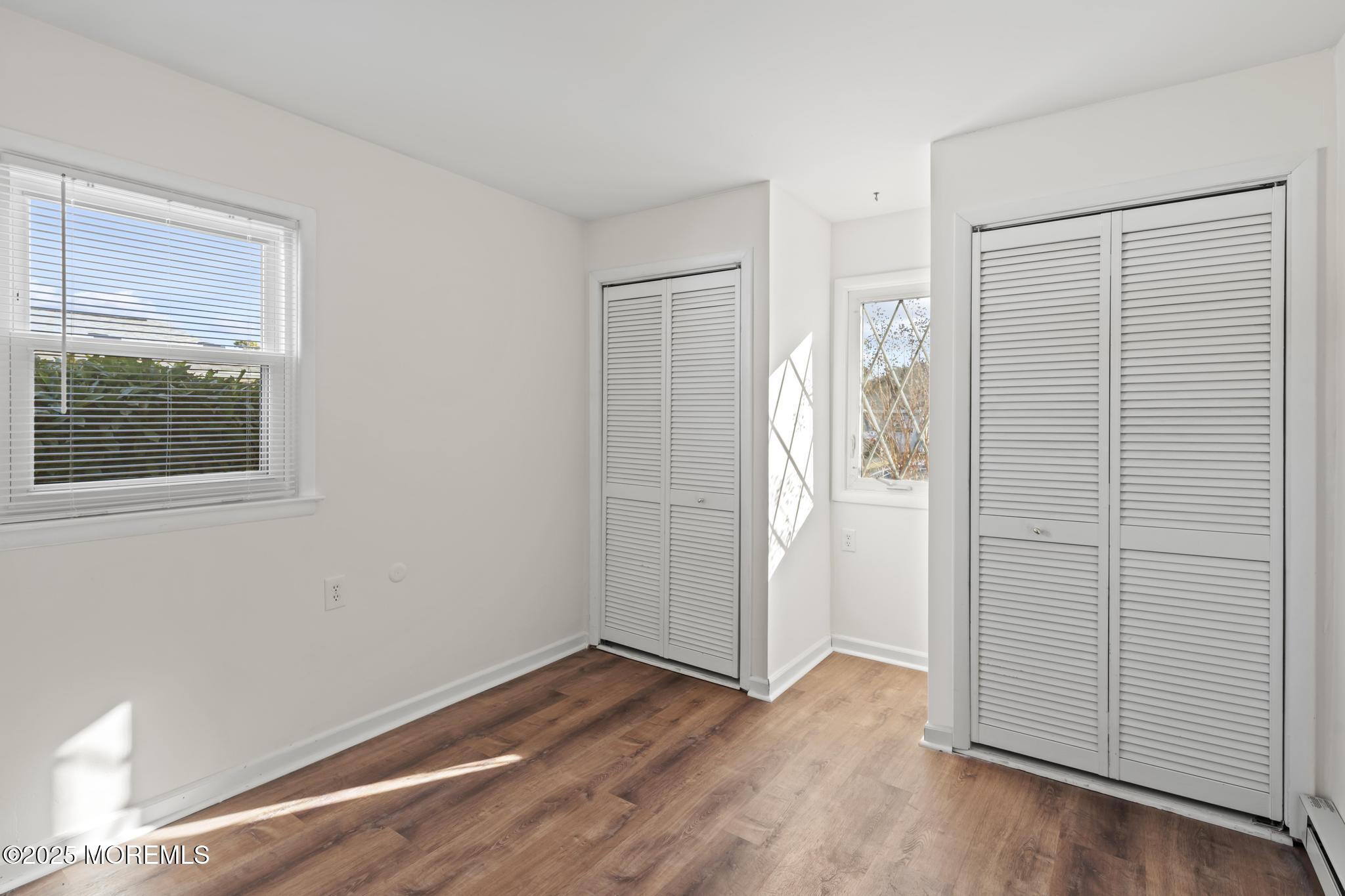 43 Patmore Road Brick, NJ 08724 - Photo 27 of 36 an empty room with wooden floor and windows