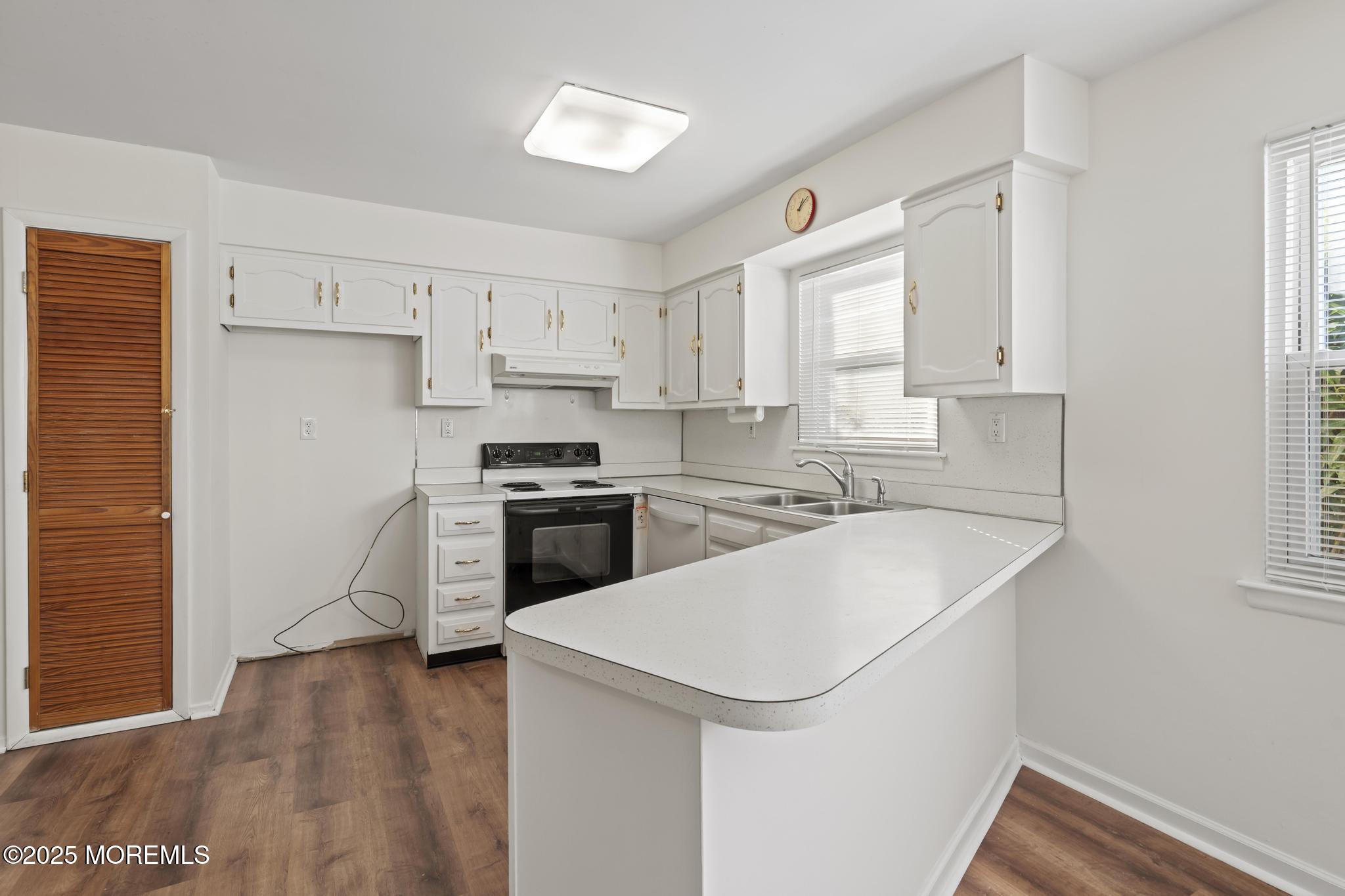 43 Patmore Road Brick, NJ 08724 - Photo 7 of 36 a kitchen with a sink a stove a refrigerator and white cabinets