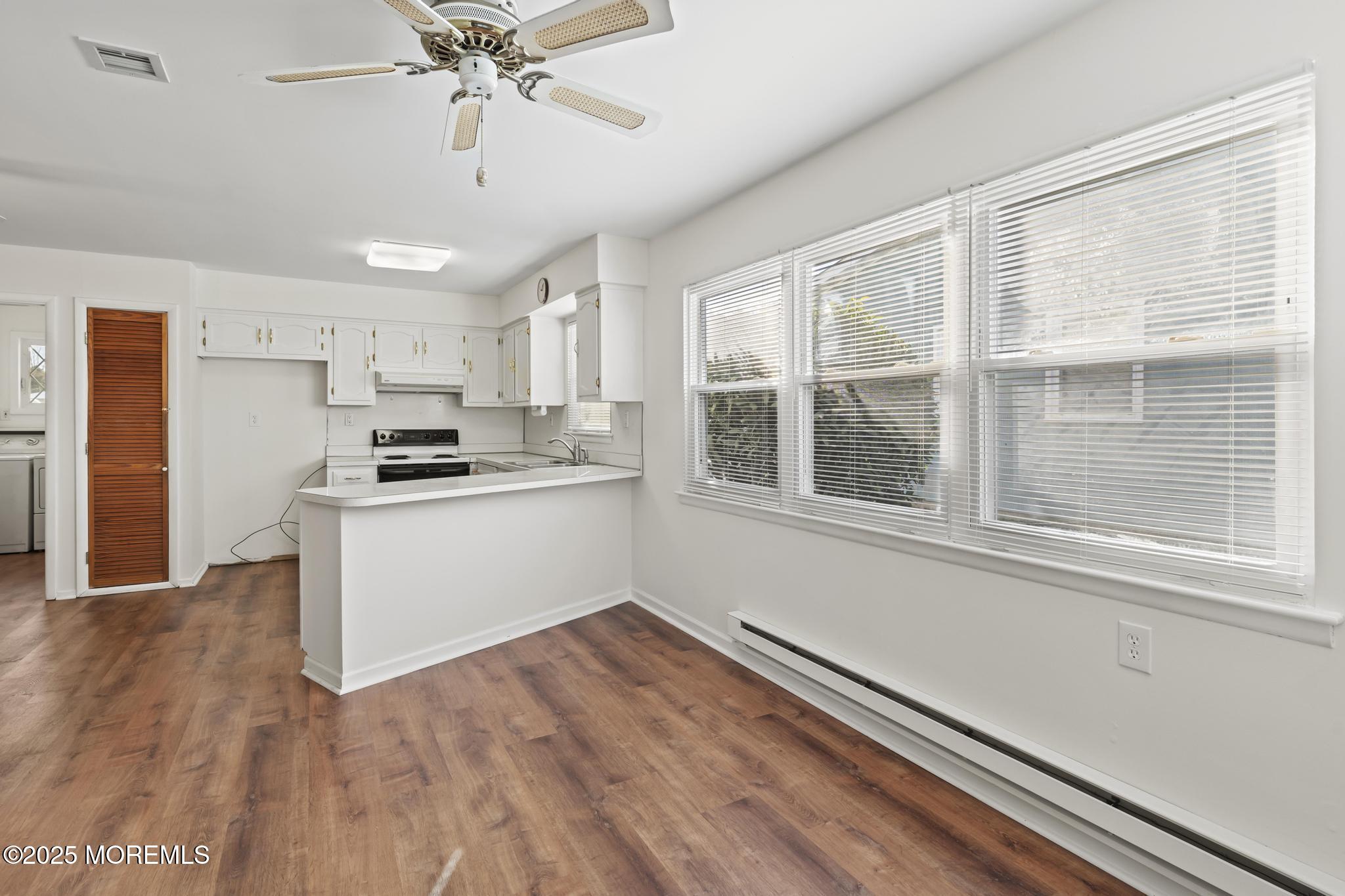 43 Patmore Road Brick, NJ 08724 - Photo 9 of 36 a kitchen with a refrigerator and windows