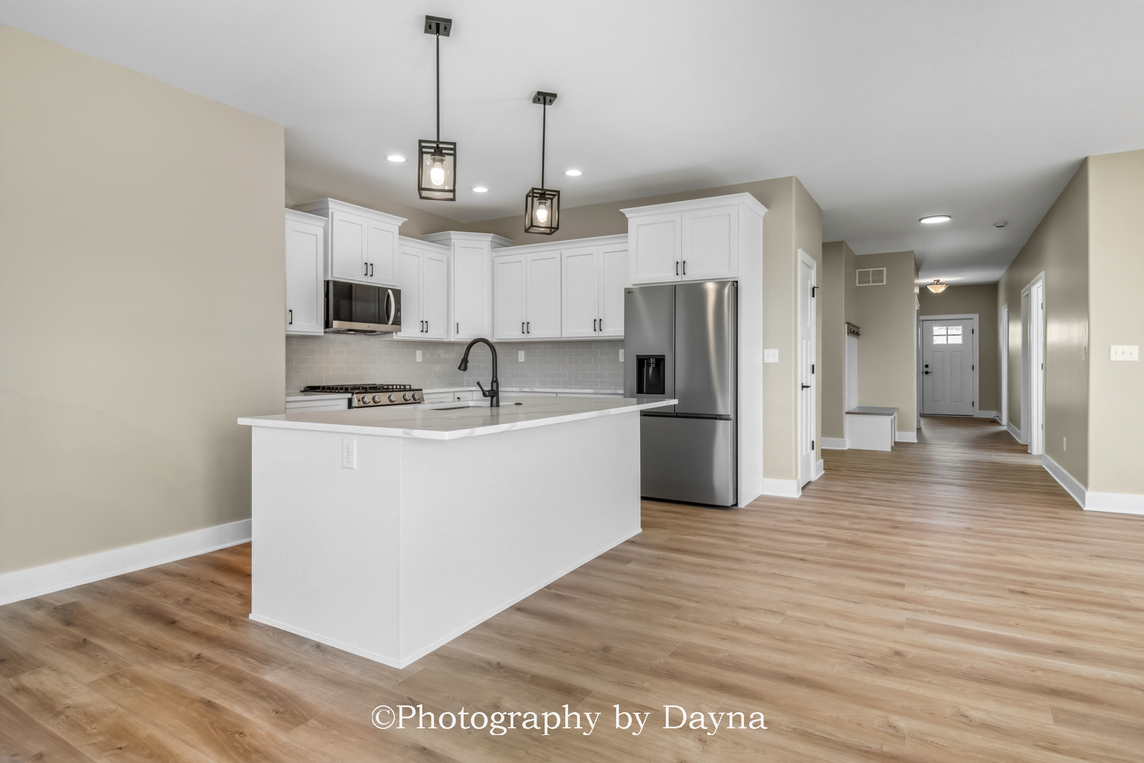 392 White Hawk Way Manteno, IL 60950 - Photo 8 of 25 a kitchen with stainless steel appliances granite countertop a refrigerator a oven a sink a stove and a wooden floors