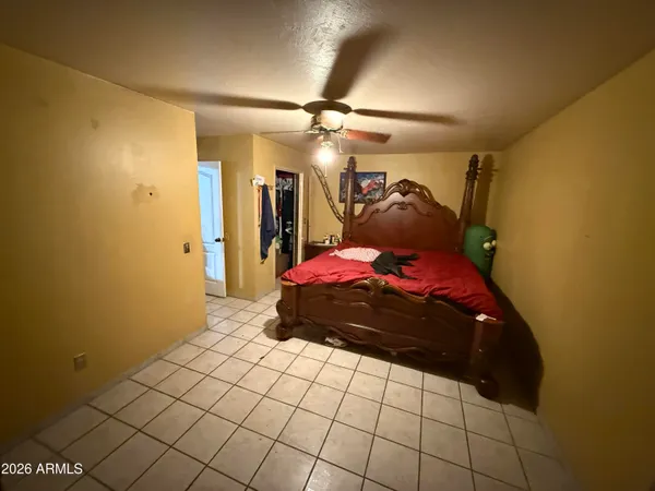 a bedroom with a bed and a chandelier