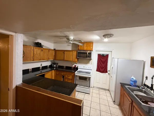 a kitchen with stainless steel appliances a stove a sink and a refrigerator