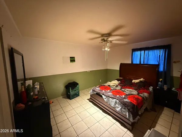 a bedroom with two beds and a chandelier