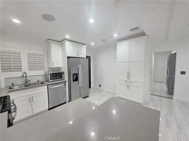 a kitchen with stainless steel appliances a refrigerator and a sink