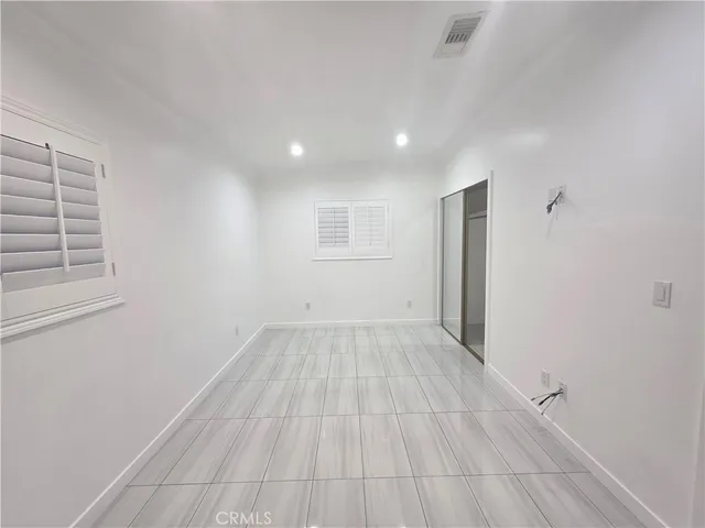 a view of a livingroom with wooden floor and window