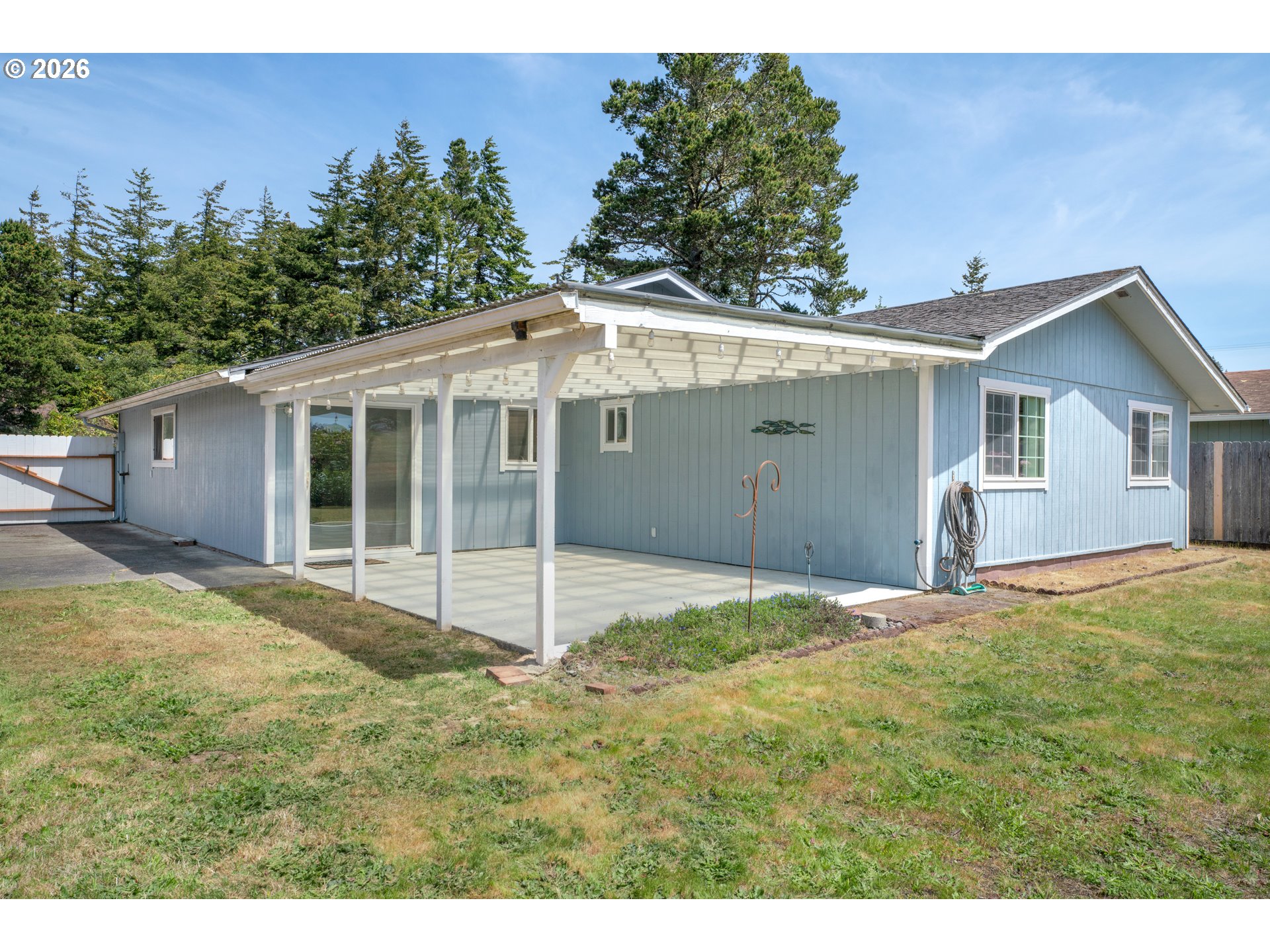 1142 9th Street Florence, OR 97439 - Photo 35 of 41 a view of a house with backyard and garden