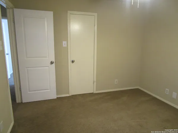 an empty room with closet area