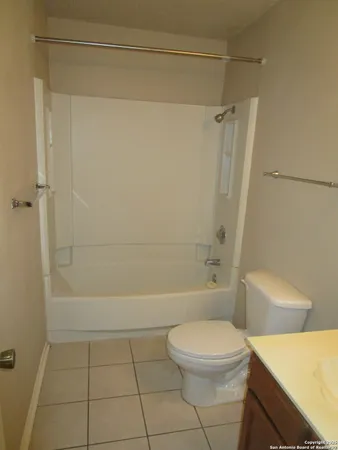 a bathroom with a toilet a sink and shower