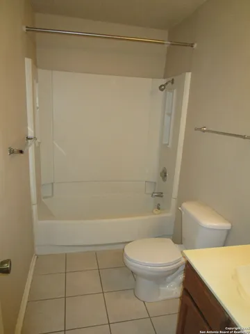 a bathroom with a toilet a sink and shower
