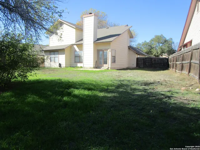 a view of a house with a backyard