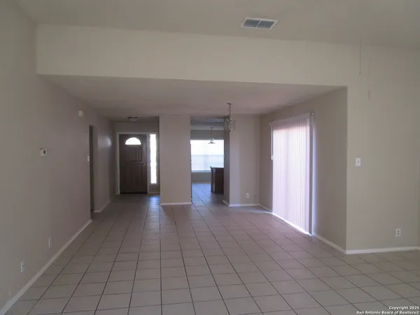 a view of a big room with wooden floor and windows