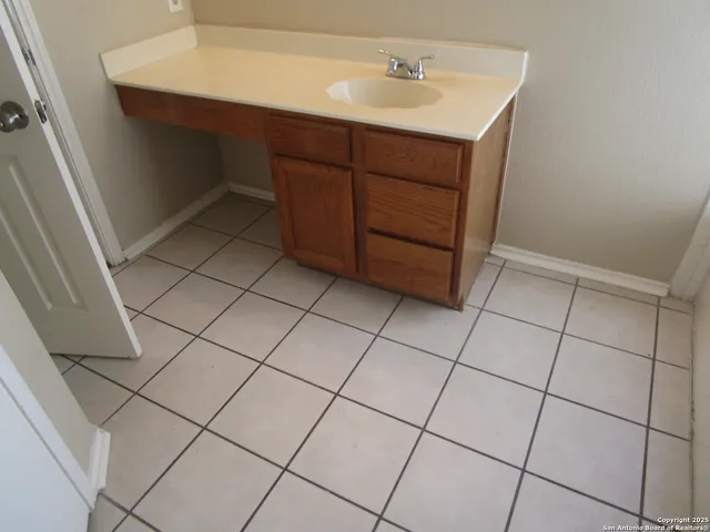a bathroom with a sink and cabinets