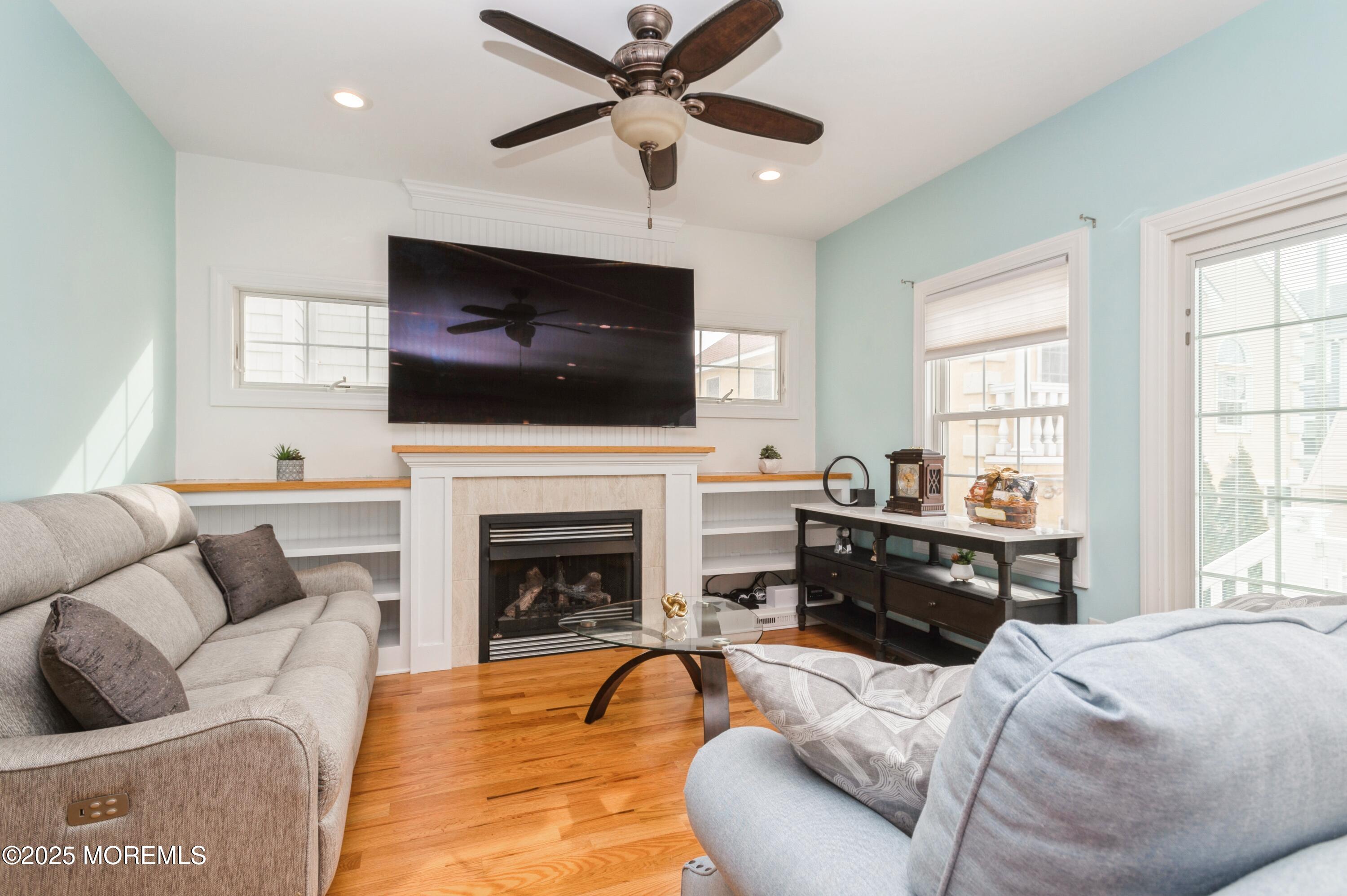 143 North Bayside Road Lavallette, NJ 08735 - Photo 3 of 23 a living room with furniture a fireplace and a flat screen tv