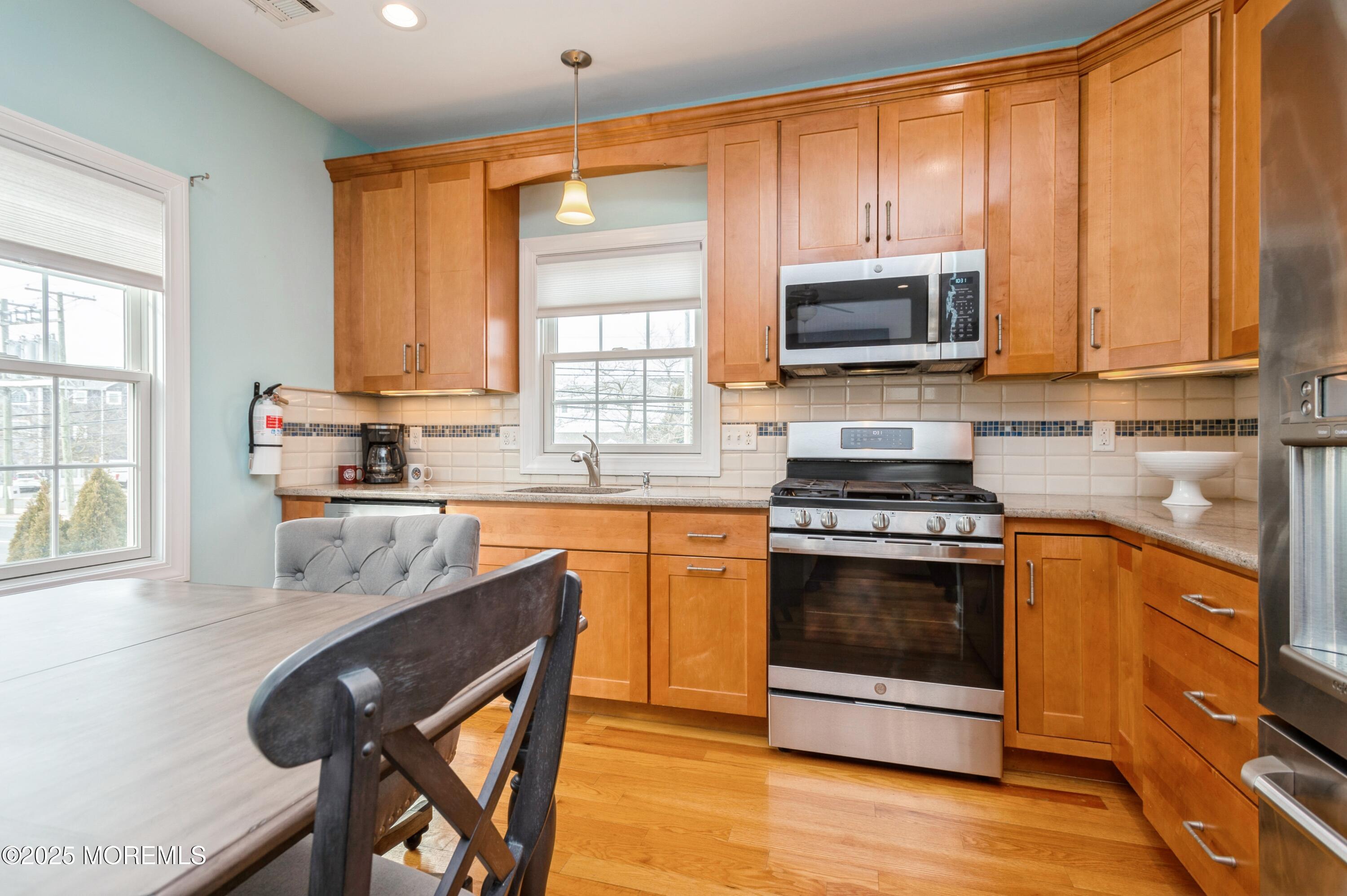 143 North Bayside Road Lavallette, NJ 08735 - Photo 5 of 23 a kitchen with stainless steel appliances granite countertop a stove a sink and a microwave